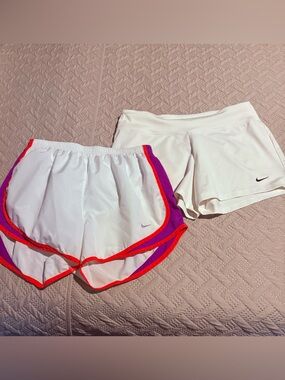 Nike Women's White Athletic Shorts with Pink & Red Trim.
